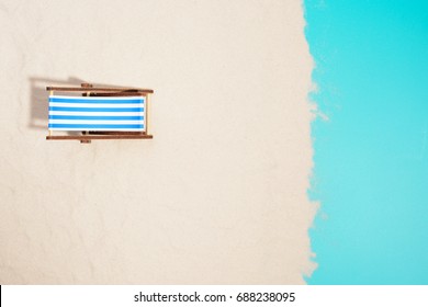 Top View Of Wooden Beach Chair On Beach.