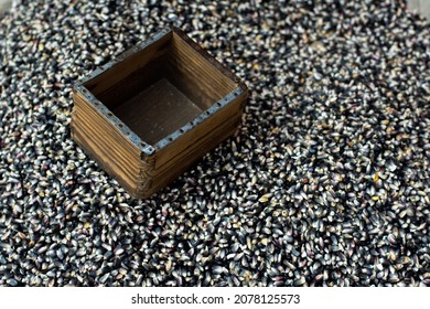 Top View Of A Wooden Box Above A Pile Of Uncooked Seeds Of Rice On A Market