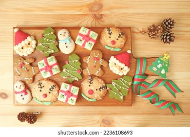 Top View of a Wooden Breadboard full of Delectable Christmas Cookies Decorated - Shutterstock ID 2236108693