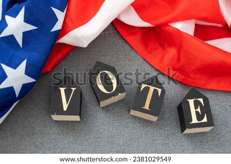 Top view of wooden cubes with letters 2024 over the American flag background. United States presidential election. Politics and voting conceptual