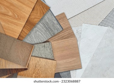 top view of wooden interior material samples swatch contains vinyl flooring tiles, engineering flooring tiles, laminated, veneer placed on concrete laminated and roller blind fabric samples.  - Shutterstock ID 2323068887