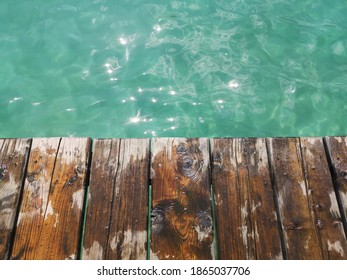 A Top View Of A Wooden Jetty Walk On Background Of Lagoon Waters