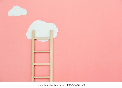 Top view wooden ladder with cloud same as step stair on  pink paper 
background, Business growth up and successful concept. copy space for text. Abstract Success stock market . management achievement.