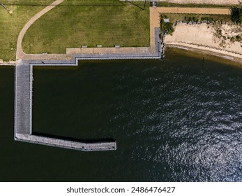 A top view of a wooden pier for fishing on a sunny day in a park on Long Island, New York - Powered by Shutterstock