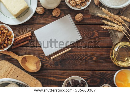 top view of wooden rustic kitchen board with organic ingredients for cooking cake. preparation for baking cake. culinary concept