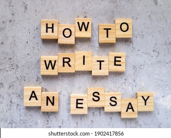 Top view of words HOW TO WRITE AN ESSAY made from wooden letters. The concept of writing skills.