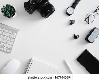 top view of work from home concept with  calculator, notebook, plastic plant, smartphone and keyboard on white background, graphic designer, Creative Designer concept. - Powered by Shutterstock