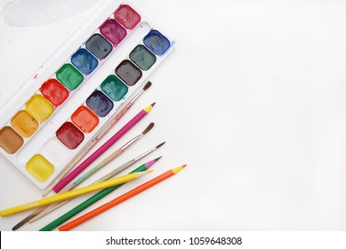 Top view of Work Process Blank Watercolor Paper pad, Watercolor Painting Supplies, Brushes and Colorful Pencil. Creation process of watercolor painting. Copy space. - Powered by Shutterstock