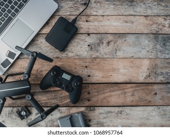 Top View Of Work Space Photographer With Drone, Memory Card, External Harddisk On Wooden Table Background With Copy Space.