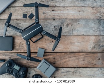 Top View Of Work Space Photographer With Drone, Memory Card, External Harddisk On Wooden Table Background With Copy Space.