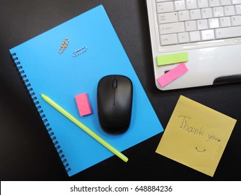 Top View Working Desk With A Yellow Sticky Note Handwritten