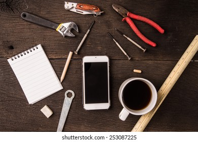 Top view Working table with black notepad and  smartphone.