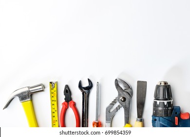 Top view of Working tools,wrench,socket wrench,hammer,screwdriver,plier,electric drill,tape measure,machinist square on white background. flat lay design.