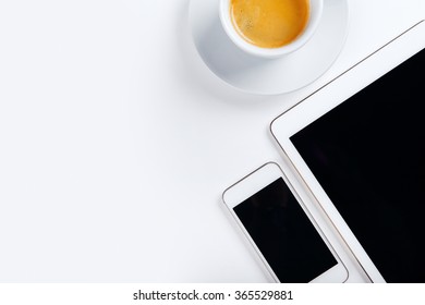 Top View Of Workplace, Tablet With Mobile Phone And Coffee On White Table