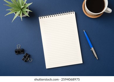 Top view of a workspace with a blank notebook, pen, coffee, and plant