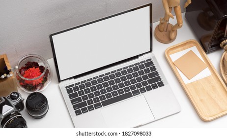 Top view of workspace with clipping path laptop, camera and supplies in home office room
