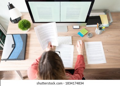 Top view of the workspace and office of a female translator working on a document and checking some references - Shutterstock ID 1834174834
