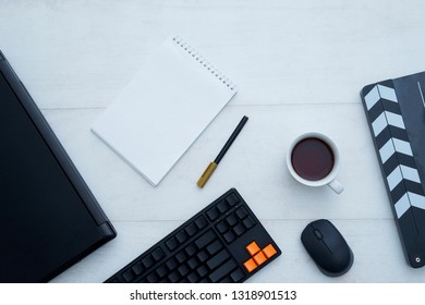 Top view of workspace with a lot of things and a cup of tea. - Image
