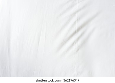 Top View Of Wrinkles On An Unmade  Bed Sheet After Waking Up In The Morning.