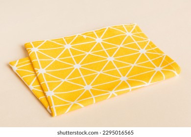 top view with yellow empty kitchen napkin isolated on table background. Folded cloth for mockup with copy space, Flat lay. Minimal style.