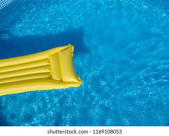 Top View Of A Yellow Inflatable Mattress In An Above Ground Private Backyard Swimming Pool