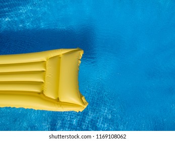 Top View Of A Yellow Inflatable Mattress In An Above Ground Private Backyard Swimming Pool