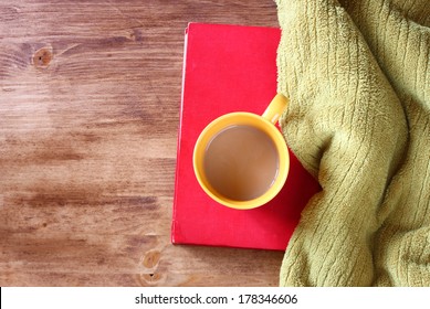 Top View Of Yellow Mug With Coffee Book And Blanket 