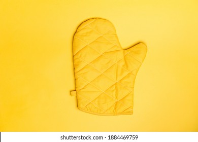 Top view of yellow oven gloves on yellow color background. Mockup for food banner and kitchen protection equipment. - Shutterstock ID 1884469759