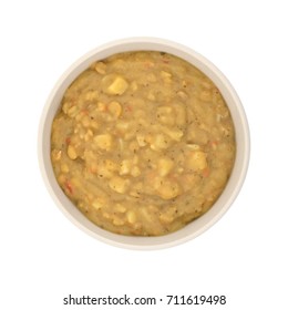 Top View Of Yellow Split Pea Soup With Vegetables In A Large Bowl Isolated On A White Background.