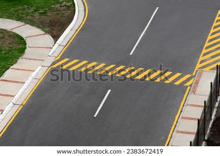 Top view of a yellow zebra crosswalk on a street