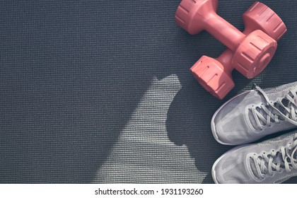 Top View Of Yoga Mat With Sport Shoes And Barbell. Concepts About Home Workout, Fitness, Sport And Health. Copy Space For Text.