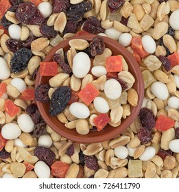 Top View Of Yogurt Covered Raisin Trail Mix With A Small Red Clay Bowl In The Center.