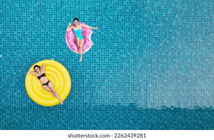 Top view of young asian woman in swimsuit on the pink donut lilo in the swimming pool. - Powered by Shutterstock