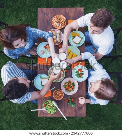 Similar – Image, Stock Photo Young friends looking map with healthy drinks and snacks