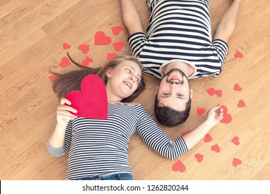 Top view young couple lying on the floor and looking to camera and smile. - Shutterstock ID 1262820244