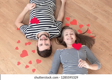 Top view young couple lying on the floor and looking to camera and smile. - Shutterstock ID 1285595329
