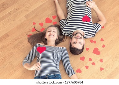 Top view young couple lying on the floor and looking to camera and smile. - Shutterstock ID 1297606984