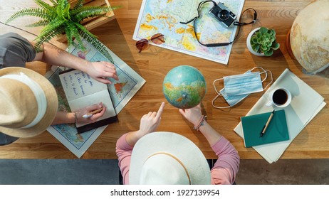 Top view of young couple with maps planning vacation trip holiday, desktop travel concept.