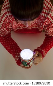 top view of a young girl looking at a mug full of christmas lights - Shutterstock ID 1518072830