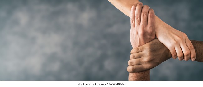 Top view of young people holding hands. Symbol and concept of unity, teamwork and support. - Shutterstock ID 1679049667