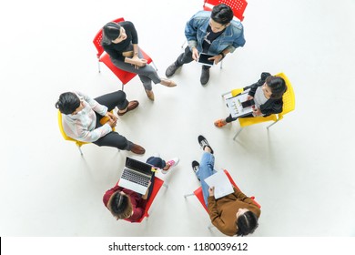 Top View Of Young People Sitting In Circle At The Meeting.