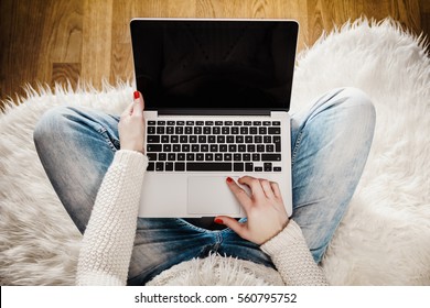 top view of a young woman with a computer on her lap - Shutterstock ID 560795752