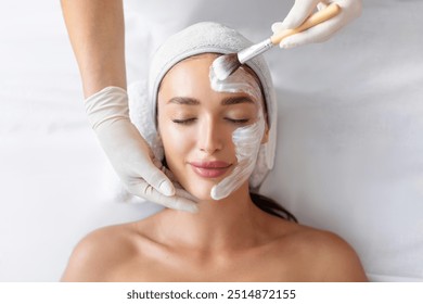 Top view of young woman enjoying luxury professional facial mask treatment. Day at spa, beauty treatment concept - Powered by Shutterstock