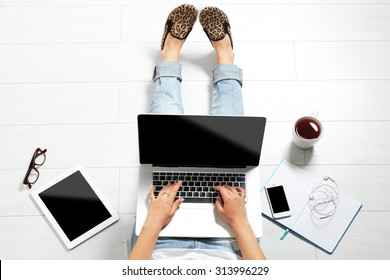 Top View Of Young Woman Sitting On Floor With Laptop