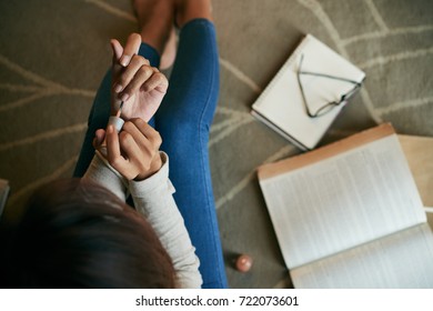 Top View Of Young Woman Sitting On The Floor And Painting Nails With Nail Polish