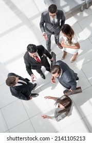 Top View.a Group Of Business People Standing On A Marble Floor.