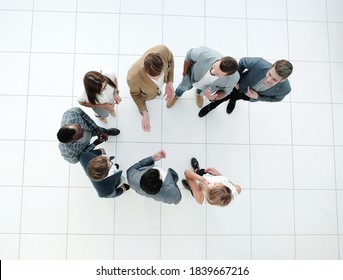 Top View.a Group Of Employees Standing In The Lobby Of The Office