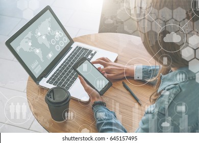 Top View,close-up Laptop On Table And Smartphone In Hands Of Young Businesswoman Sitting At Round Wooden Table And Working Online. Girl Learning.In Foreground Virtual Icons With Cloud,people, Gadgets.