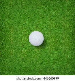 Top views of golf ball on green grass texture background.