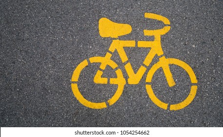Top - view,Yellow bike symbol on the street in Urban city. transportation concept